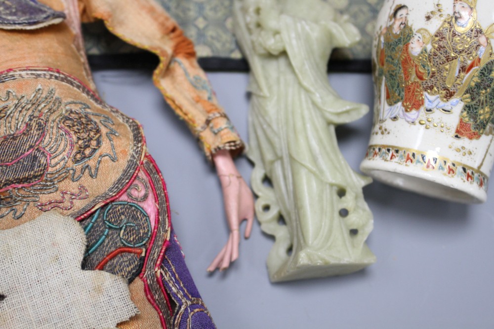 A small Cantonese porcelain teapot, a Satsuma vase, a silkwork panel, a doll and a broken soapstone figure